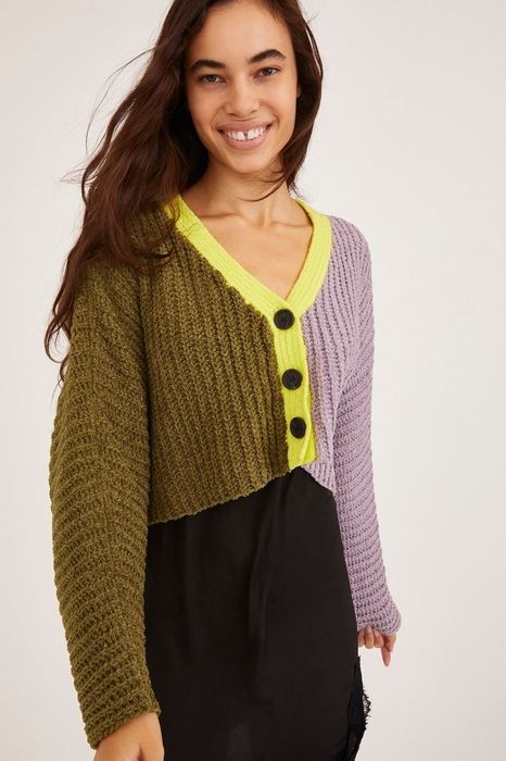 A half purple, half olive sweater with three buttons and a yellow collar.
