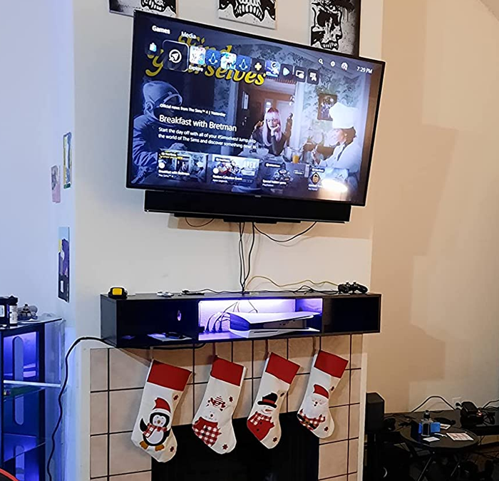 Customer-submitted image of black TV stand with LED lights on the wall