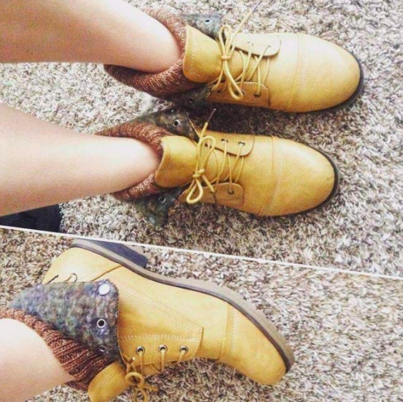A reviewer wears boots with sides that can be folded down.