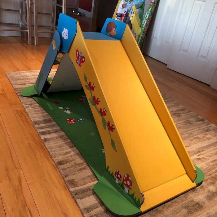 A review photo of the slide featuring vibrant green, yellow, and blue colors with playful animal and plant designs