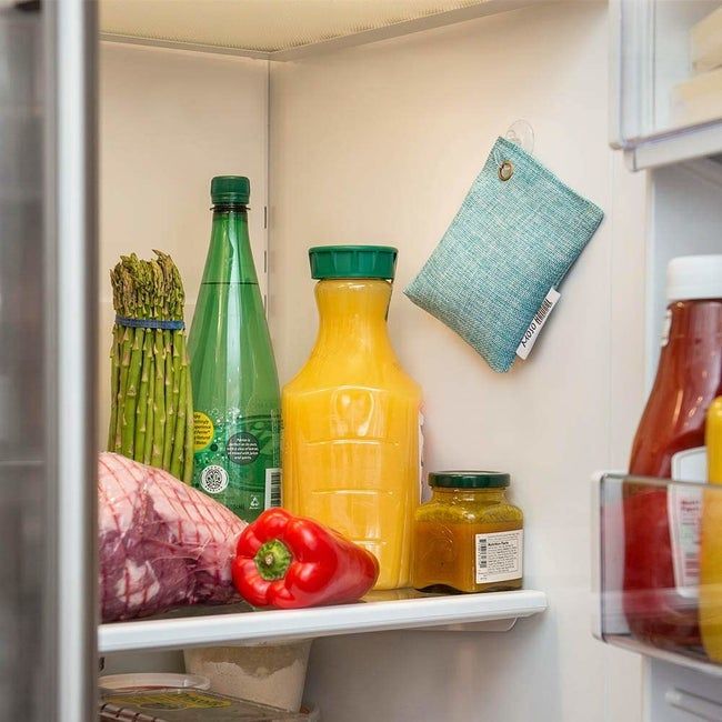 A blue bag hanging from the fridge door.