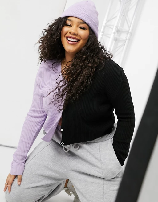 A model showcases a cardigan that's split between black and lavender shades.
