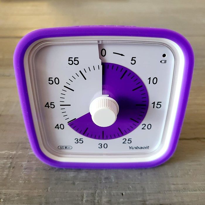 A reviewer's photo of a purple and white Yunbaoit 60-minute timer, displaying approximately 40 minutes, placed on a wooden surface.