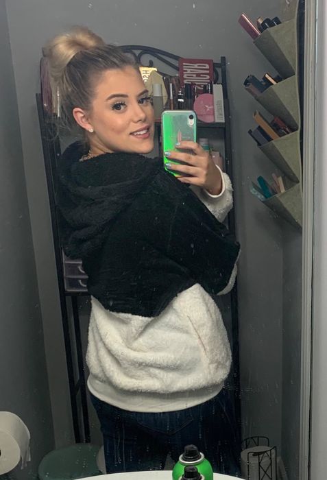 The reviewer showcases the back of the fleece jacket.