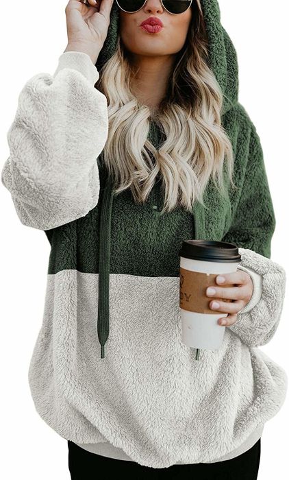 The model is wearing a two-toned fleece jacket with a hood.