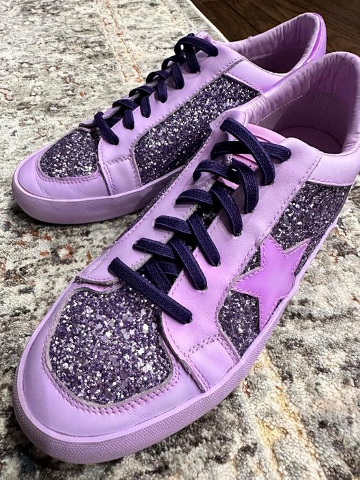 Reviewer's image of purple sneakers featuring glitter accents and a star motif on the side, paired with purple stretch laces