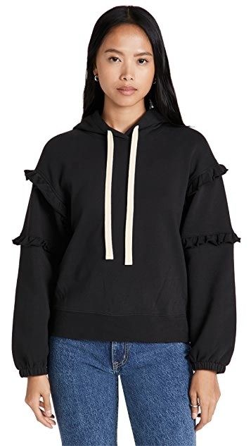 A model wears a sweatshirt adorned with ruffles along the sleeves.