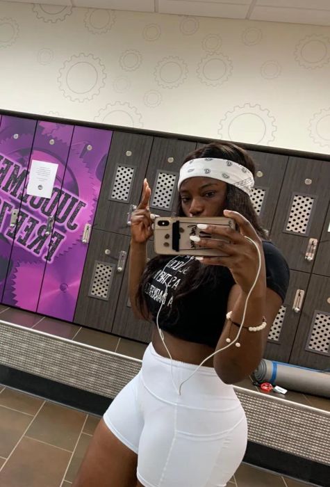 Another reviewer snapping a selfie in crisp white biker shorts.