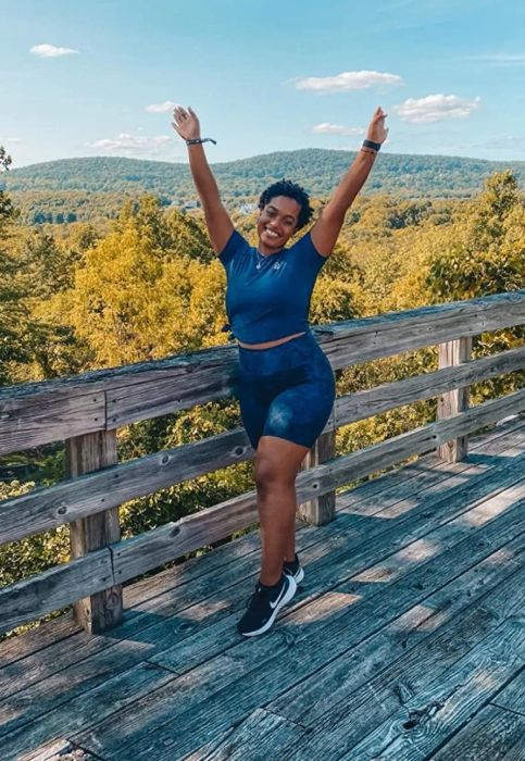 A reviewer showcasing the bike shorts featuring a blue snake print design