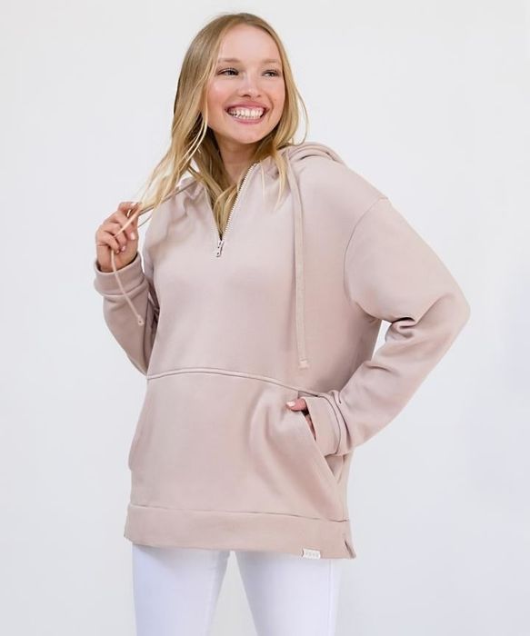 A model is seen wearing a rose pink hoodie.