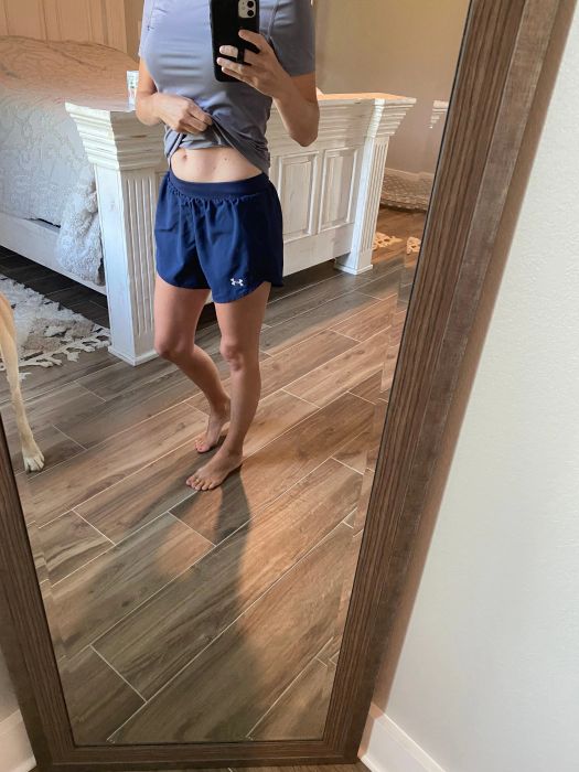 Another reviewer showcasing the shorts in a vibrant blue color.