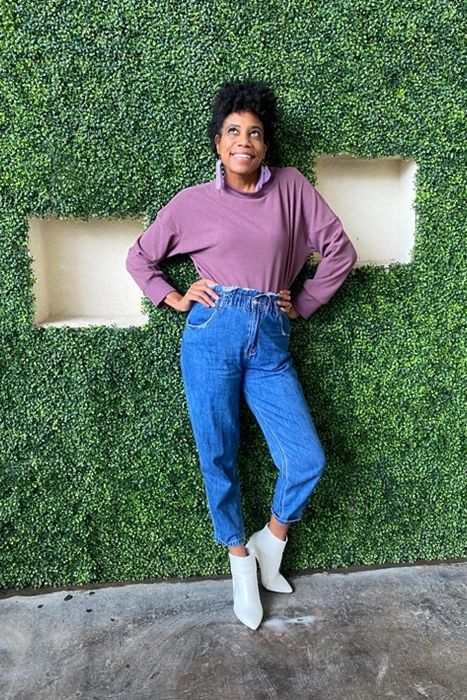 reviewer rocking the sweatshirt in purple, tucked into jeans.