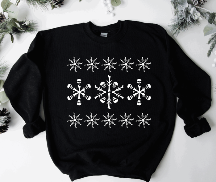 A sweatshirt featuring a snowflake pattern, which reveals a design made up of skulls and bones when you take a closer look.