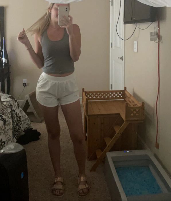 A reviewer snapping a mirror selfie while wearing the shorts.