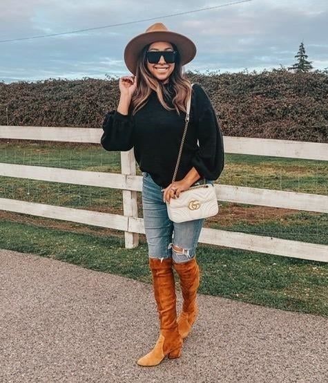A reviewer wearing the sweater in black