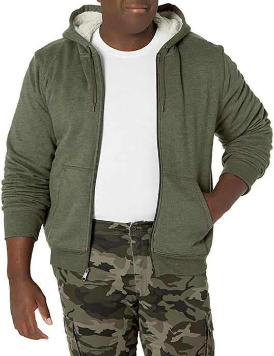 A model is seen wearing a zip-up hoodie with a sherpa lining.