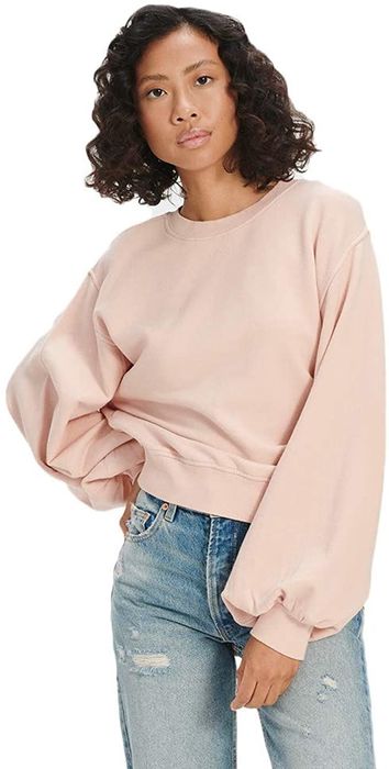 A model is sporting a sweatshirt with exaggerated balloon sleeves for that statement look.