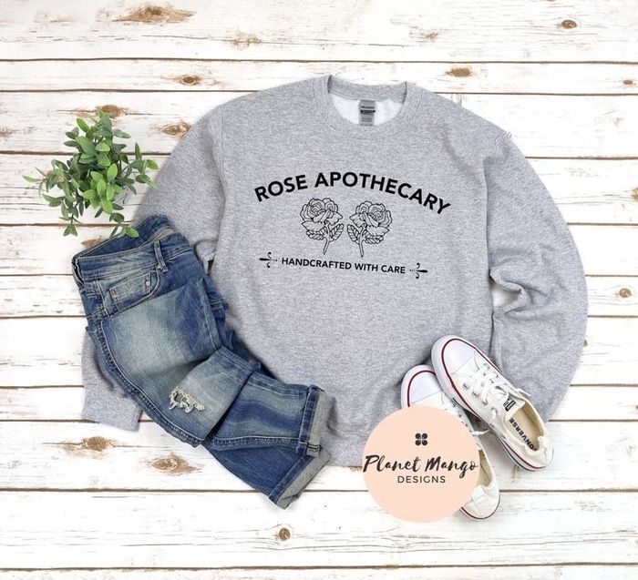The sweatshirt features the Rose Apothecary logo and the text 'handcrafted with care.'