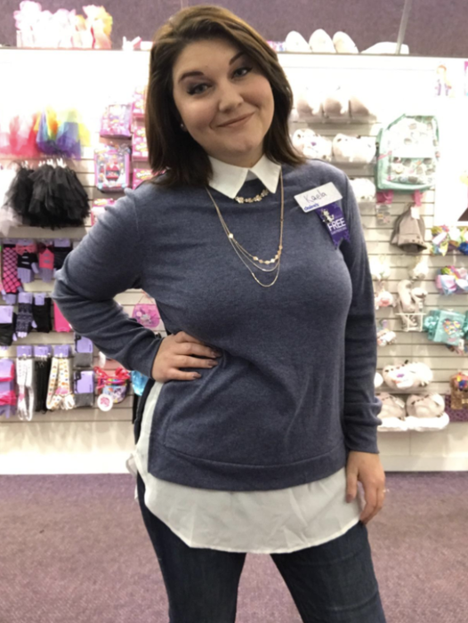 A person is seen wearing a sweatshirt that mimics the appearance of a button-down collar shirt underneath.
