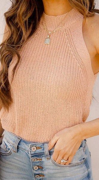 A model wearing the pink knit halter top.