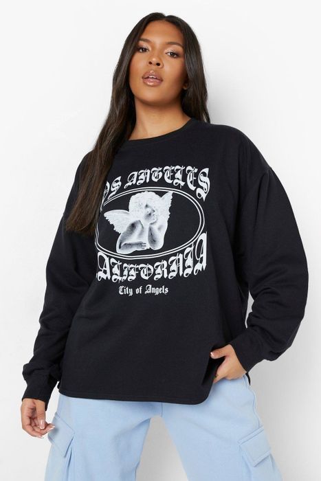 A person is wearing a shirt with 'Los Angeles' printed on it alongside an angel graphic.