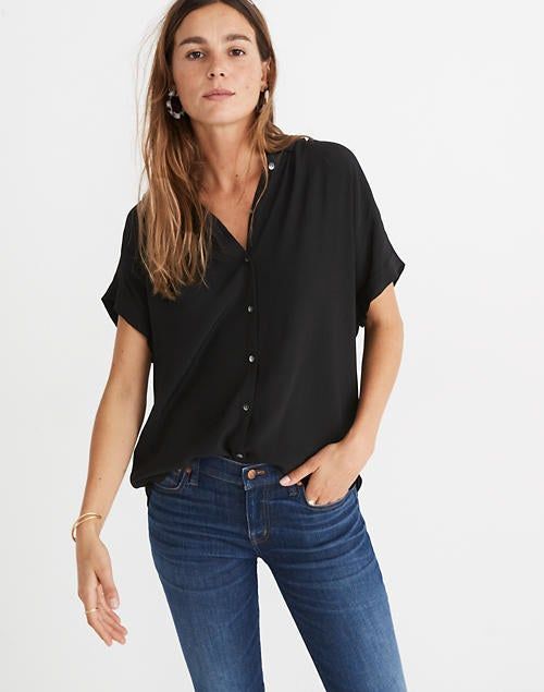 Front view of a model wearing the blouse in black.