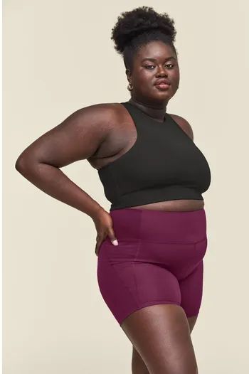 Another model showcasing plum-colored shorts in a striking pose