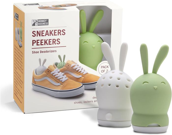 Two bunny-shaped sneaker deodorizers, one white and one green, along with their packaging.