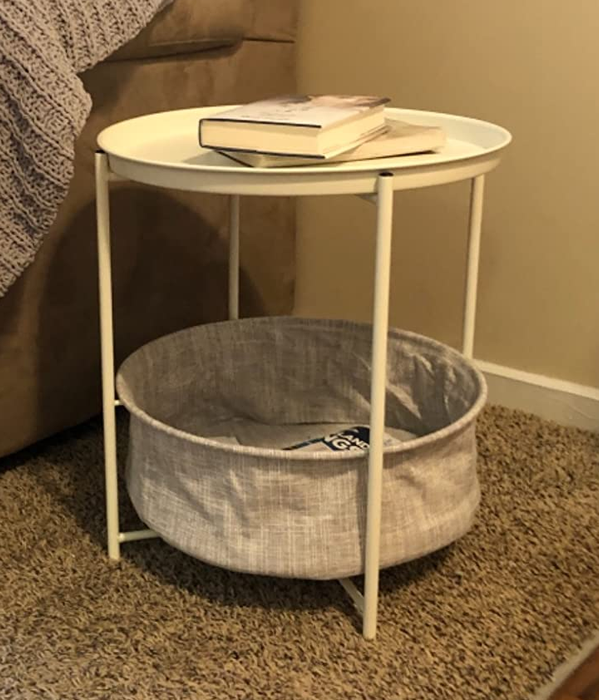 Reviewer image of a white end table with storage placed beside a couch