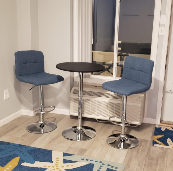 Reviewer image showing a black pub table with two blue chairs