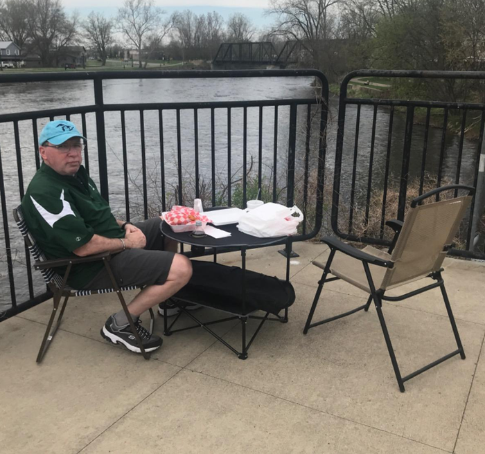 Reviewer using a black picnic table