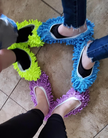 Three reviewers are wearing green, blue, and purple slippers.