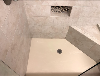 The shower floor is now sparkling clean.