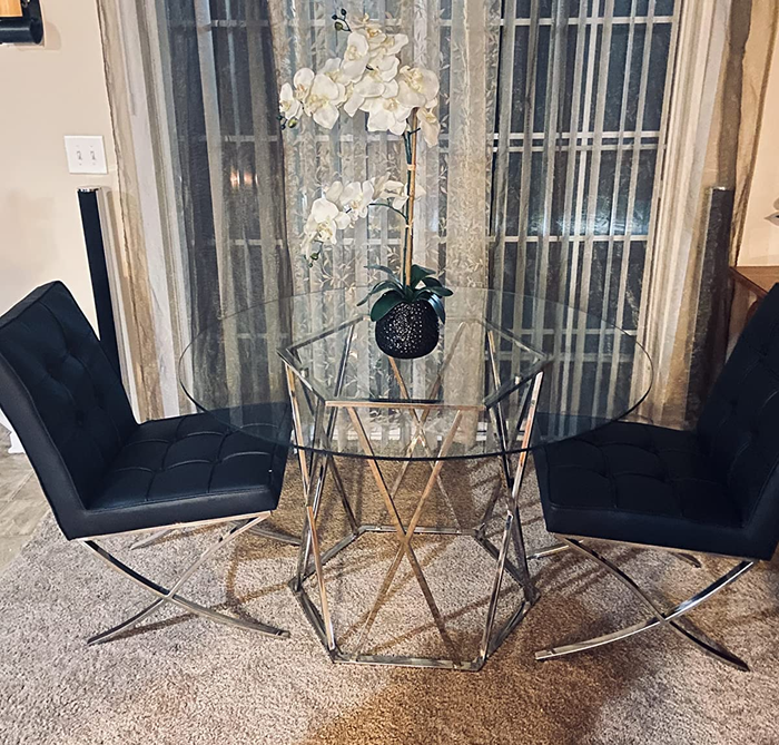 Customer photo of the round table with black chairs