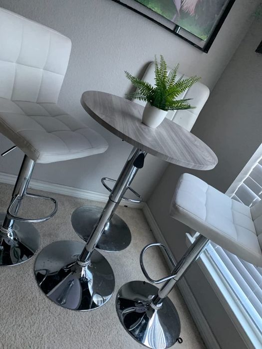 Reviewer image of a gray pub table and two white chairs