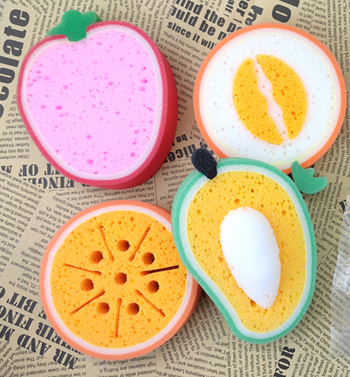 Sponges shaped like halved strawberries, avocados, oranges, and melons.