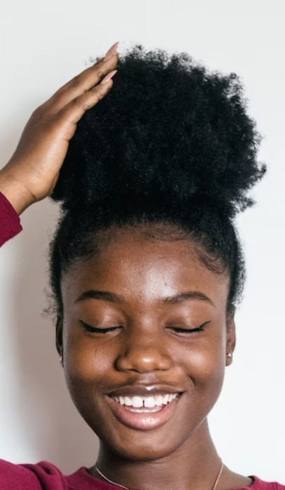 A model's hair styled in a puff, held in place with a magnetic hair tie.