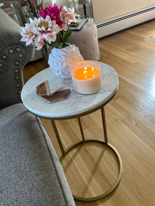 Customer photo of the table with a candle and flowers displayed on it