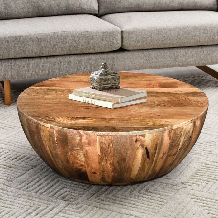 Image of a brown wood coffee table with books on it