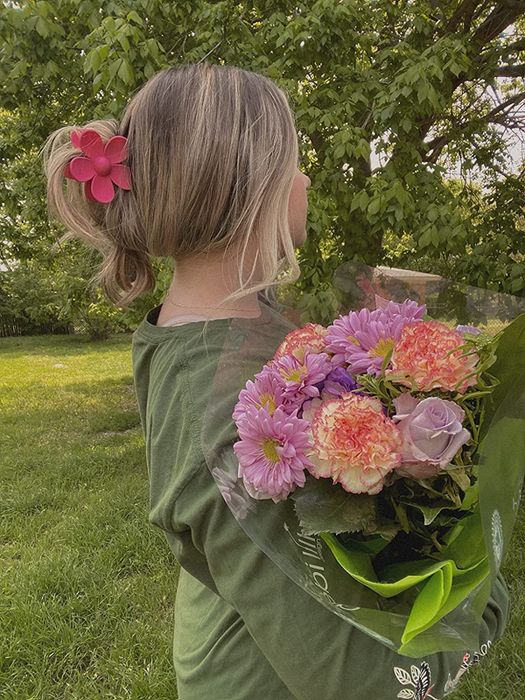 Customer wearing the red floral clip in their hair