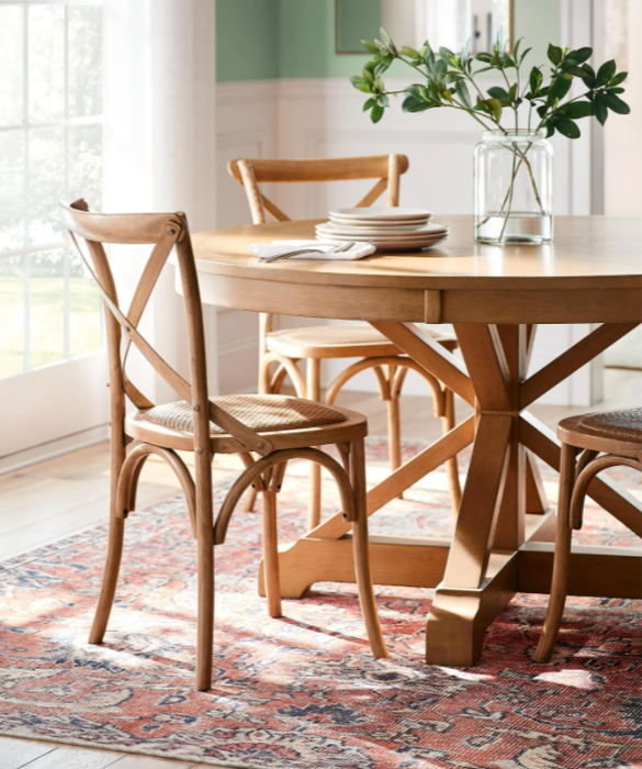Image of a brown table with chairs and a plant on it