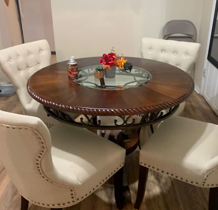 Reviewer image of a brown table with four white chairs