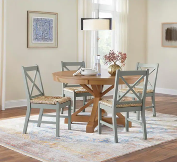 Image of a brown table with chairs and a plant on it
