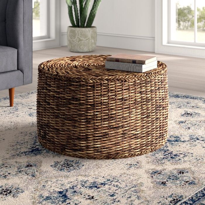 Image of a brown rattan/wicker coffee table with books placed on top