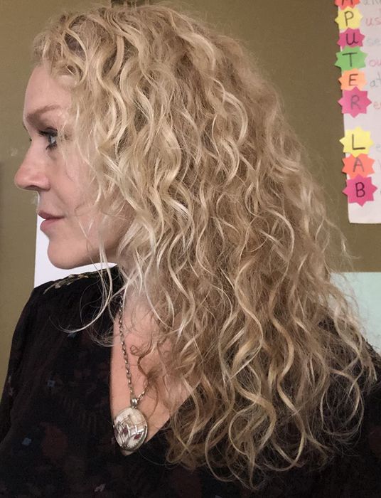A reviewer's hair after using the Cantu curling cream