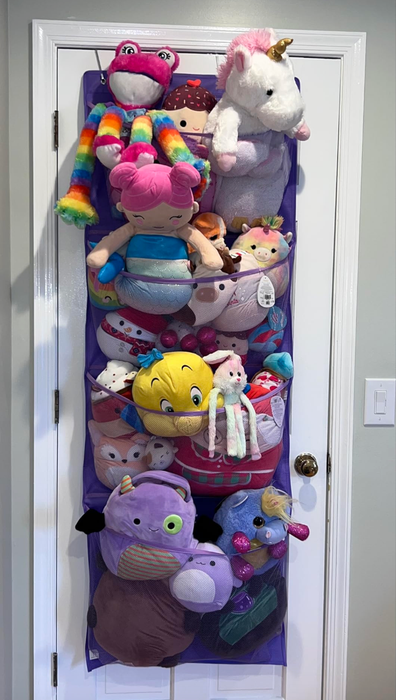 A door-mounted organizer packed with various stuffed animals and soft toys.
