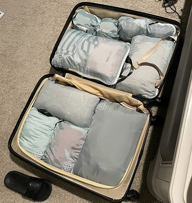 A suitcase neatly packed with compression cubes.