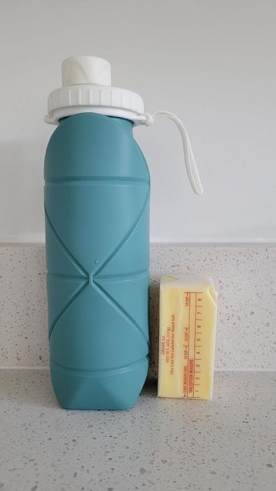 The water bottle placed next to a half stick of butter
