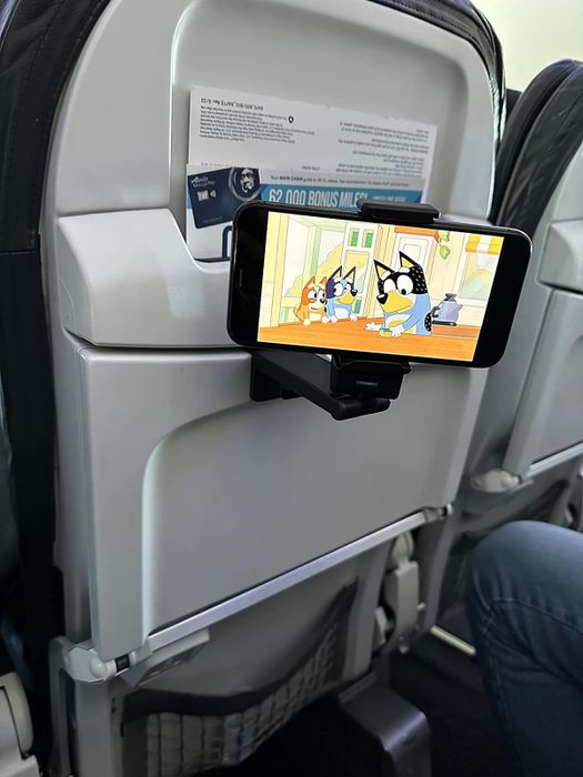 a phone attached to the back of a seatback tray