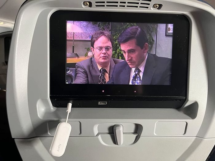 the airfly transmitter connected to the airplane seat display